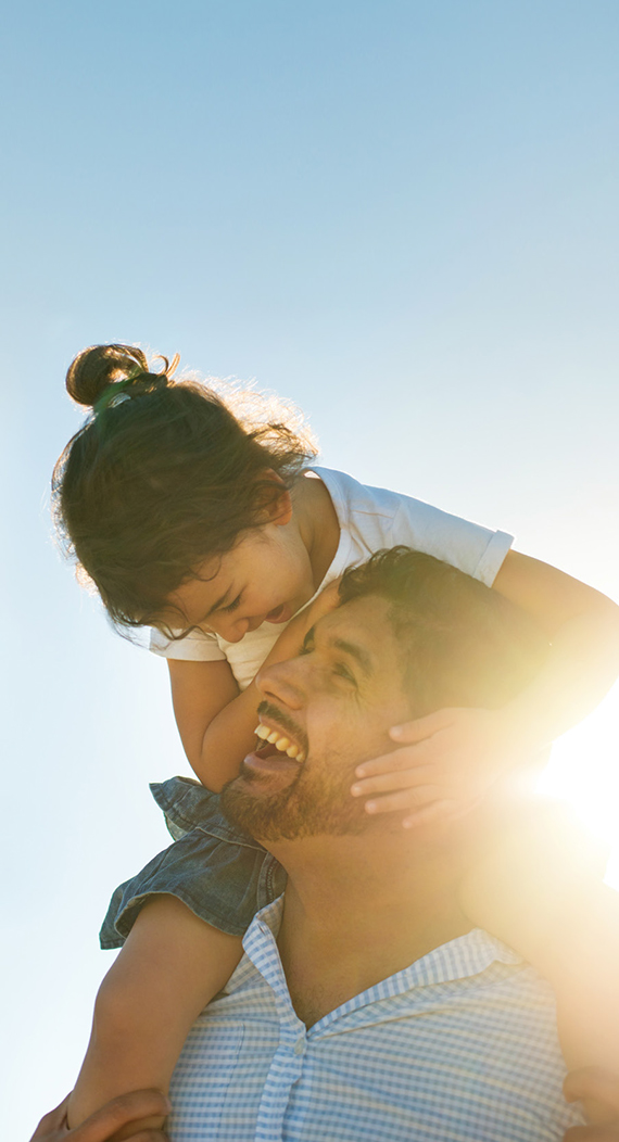 Father holding daughter on his shoulders