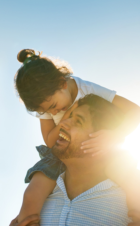 Father holding daughter on his shoulders